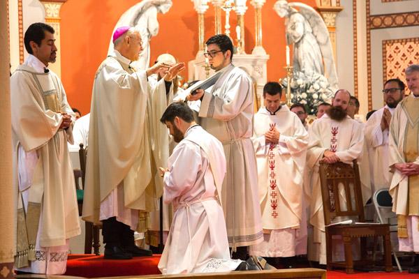 During the prayer of ordination, Bishop Taylor prays over Jon Miskin, which is the essential act of ordination. (Bob Ocken photo)