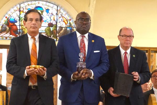 North Little Rock’s Chief of Staff Danny Bradley (left), Little Rock Mayor Frank Scott Jr. and Pulaski County Judge Barry Hyde bring the gifts to the altar during the Red Mass on Oct. 4 at the Cathedral of St. Andrew in Little Rock. (Aprille Hanson photo)