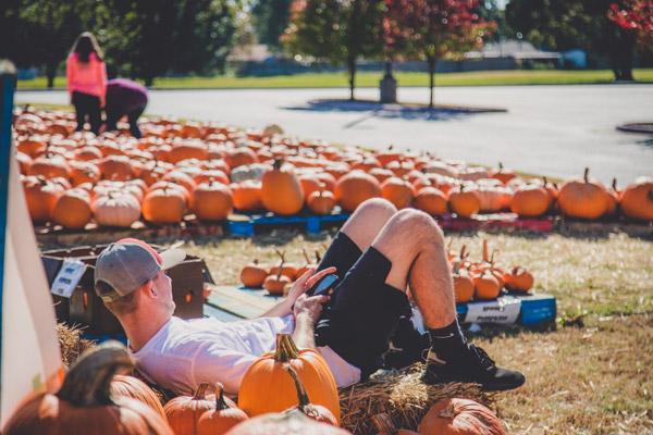 Youth Leader Cole Hartman kicks back and takes a break while at the youth group pumpkin patch fundraiser. (Travis McAfee photo)