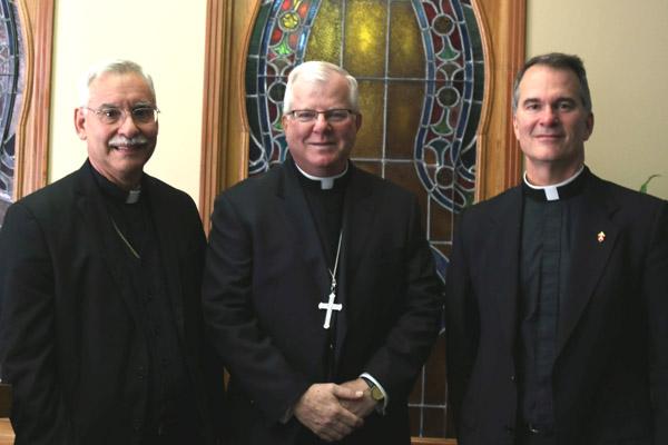 Bishop-elect Francis I. Malone (center) smiles after the press conference where he was introduced as the next bishop of Shreveport, joining only two other Arkansas priests elevated to bishop. He was joined at the event Nov. 19 by Bishop Anthony B. Taylor and Shreveport diocesan administrator Father Peter Mangum. (Samantha Maiette, Diocese of Shreveport)