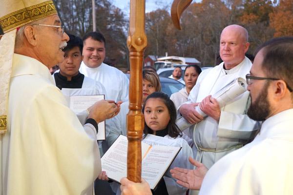 In 2019, St. Luke Church in Warren became the first parish to benefit from the year-long One Church mission. In a ceremony before Mass Nov. 23, Bishop Anthony B. Taylor hands the keys to the new church to the pastor, Father Eddie D’Almeida (right). (Malea Hargett, Arkansas Catholic file) 