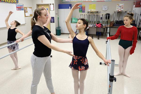Maria Dumond takes pointers on her form from ballet instructor Rachel Hicks. Dumond, a sixth-grader who has a goal of dancing professionally one day, describes dance as a good source of stress relief. (Dwain Hebda photo)