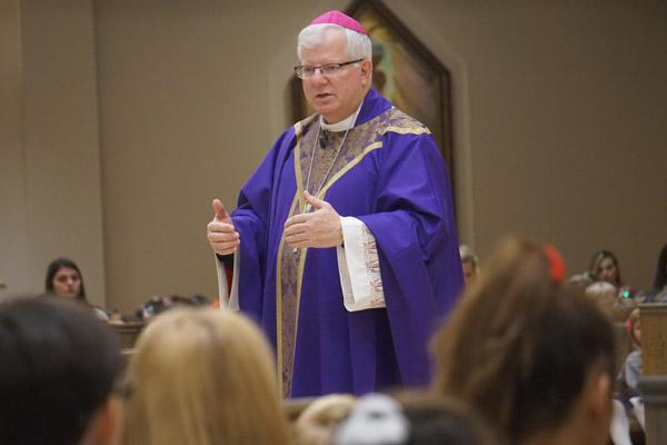 Bishop-elect Francis I. Malone preaches his finally homily to students during his final school Mass Dec. 20 at Christ the King Church. He explained to students that there was happiness and sadness in leaving to become bishop of Shreveport, La. (Aprille Hanson photo) 