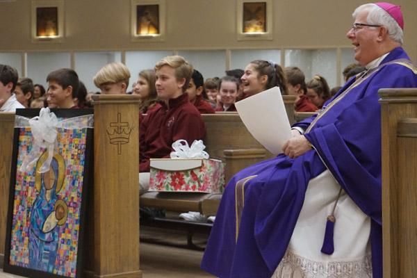Bishop-elect Malone laughs along with students at a funny memory shared following his final Mass with Christ the King School Dec. 20. (Aprille Hanson photo) 