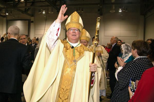 At the end of Mass, Bishop Francis I. Malone walks through the crowd, blessing the congregation for the first time as a bishop. The crosier was used by the late Bishop Andrew J. McDonald and was lent to Bishop Malone to use while he serves in Shreveport. (Bob Ocken photo)