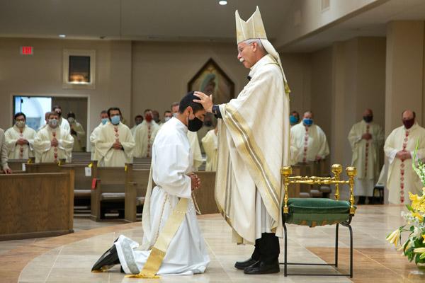 Bishop Anthony B. Taylor lays hands on Father Daniel Velasco in silence, to receive the strength of the Holy Spirit. 