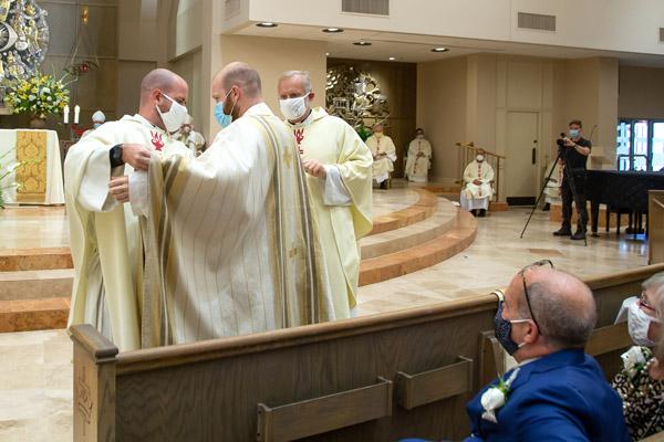 Father Joseph Friend was vested during his ordination Aug. 15 by his brother, Father Patrick Friend, ordained in 2018, and his uncle Msgr. Scott Friend, vocations director for the Diocese of Little Rock. (Bob Ocken photo)