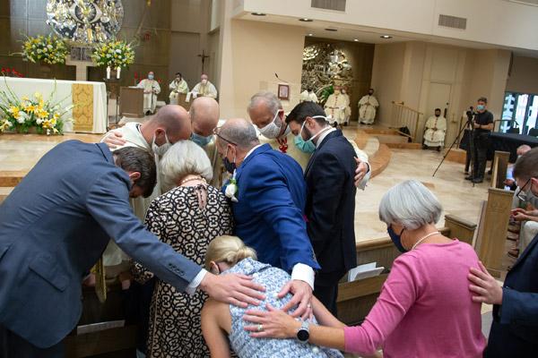 Father Joseph Friend gives his family his first blessing after being ordained to the priesthood Aug. 15 at Christ the King Church in Little Rock. (Bob Ocken photo)