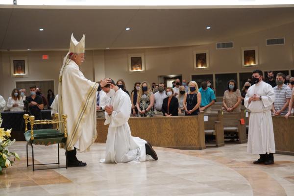 In silence, Bishop Anthony B. Taylor lays his hands on Ben Riley, calling upon the Holy Spirit for strength. (Malea Hargett photo)