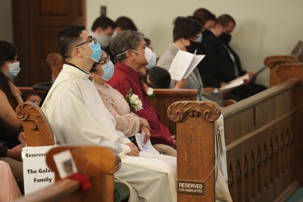 Deacon Omar Galván sits with family during his diaconate ordination Aug. 12 at Immaculate Conception Church in Fort Smith. (Travis McAfee photo)