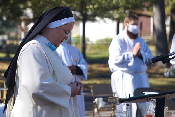 Sister Mary Clare Bezner, OSB, diocesan minister for religious, leads a rosary Nov. 2 at Calvary Cemetery in Little Rock. Because of COVID-19 distancing guidelines, the faithful did not process around the cemetery with the bishop but stayed at their seats to pray the rosary. (Aprille Hanson photo) 