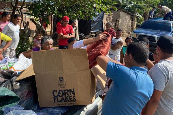Residents of Trujillo, Honduras, receive clothes and other supplies Nov. 13 after Hurricane Eta, which destroyed houses and passages to several villages. (Courtesy Dixiana Hernandez)