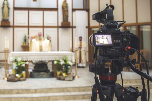 Before public Masses were able to restart, Pastor Father John Connell celebrates Mass at St. Raphael Church in Springdale on Holy Saturday, April 11, livestreaming on Facebook. (Travis McAfee photo, Arkansas Catholic file)