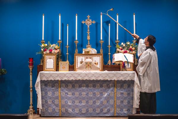 Candles are lighted for the first time at the new parish for the Latin Mass community in northwest Arkansas. (Travis McAfee photo)