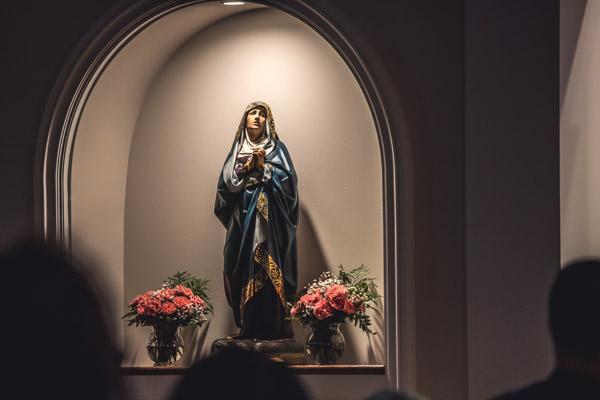 A statue of Our Lady of Sorrows is illuminated during the dedication of Our Lady of Sorrows Parish in Springdale Dec. 12. The growing Latin Mass community in northwest Arkansas established their own parish with about 55 families. (Travis McAfee photo)