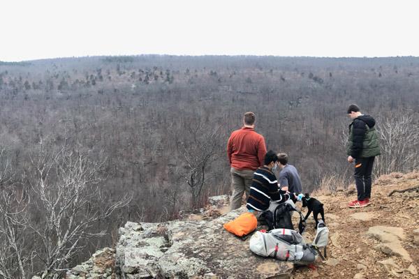 Subiaco Academy students Jacob Casey (left), Jesus Deonate, Robby Russel and Aiden Harris and dog Bella pause atop a bluff at Mount Magazine after hiking on the Bear Hollow Trail Jan. 24. Nick McDaniel leads the Outdoor Adventure Program for the academy. (Nick McDaniel) 