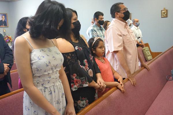 Noel and Yolanda Berumen stand with daughters Emily (left) and Isabella during the Spanish Easter Mass April 4 at the St. Oscar Romero Catholic Community in Greenbrier. The family attended one of the first two Masses in a year held in the community’s rented space. (Aprille Hanson Spivey photo)