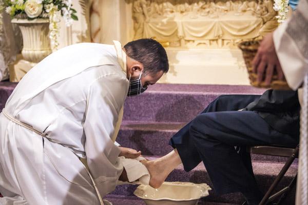 Pastor Father Ruben Quinteros washes a parishioner’s foot during the Holy Thursday Mass April 1 at Immaculate Heart of Mary Church in North Little Rock (Marche). (Travis McAfee photo) 