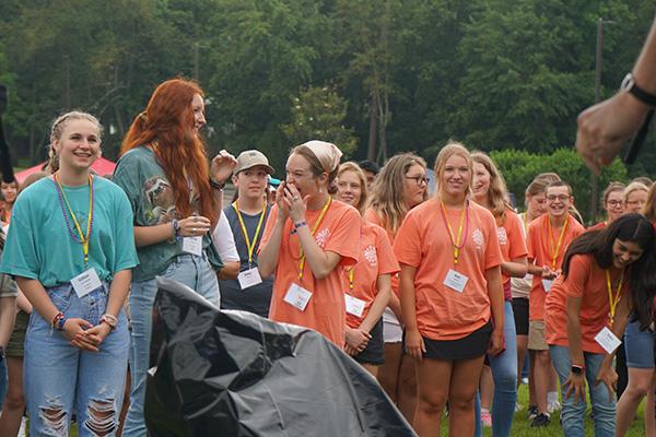 Participants laugh during a fast-paced game of Simon Says at the start of the youth rally. (Malea Hargett photo)