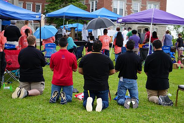 Five diocesan seminarians kneel during Mass celebrated by Father Jeff Hebert at the conclusion of Glory on the Grounds June 6. (Malea Hargett photo) 