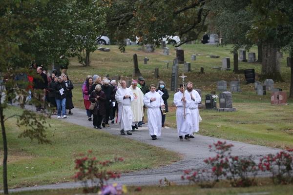 Bishop Anthony B. Taylor leads the congregation in praying the rosary as they walk through Calvary Cemetery following the All Souls Mass in Little Rock Nov. 2. (Photo Chris Price)