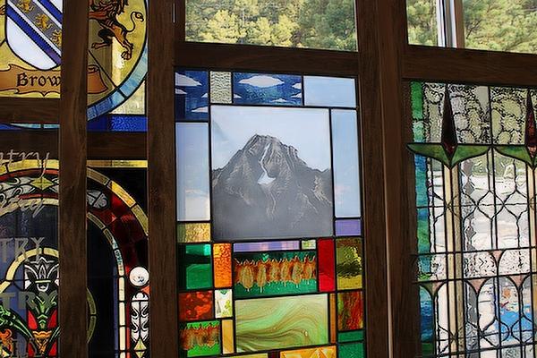 Window featuring a mountain scene and autumn leaves at Soos Stained Glass in North Little Rock Sept. 20. Chris Price photo.