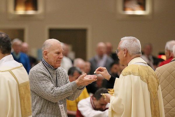 Deacon Richard Papini of St. Joseph Church in Conway receives the Eucharist from Bishop Anthony B. Taylor at the 13th annual Arkansas Catholic Men's Conference at Christ the King Church in Little Rock on “Super Bowl Saturday,” Feb. 11. (Chris Price photo)
