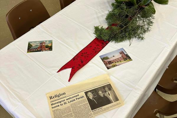 Courtesy St. Louis Church. St. Louis Church held a large catered banquet Sunday Dec. 10 after Mass. In the dining hall, tables were covered with old photographs and newspaper clippings with the history of the church to remind parishioners of the church’s history.