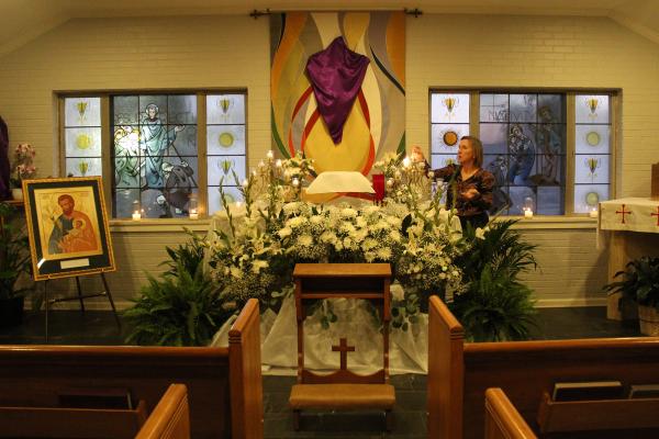 Taffy Council, a parishioner at Our Lady of Fatima Church in Benton, prepares the adoration chapel altar for adoration after the Holy Thursday Mass March 28. (Katie Zakrzewski)