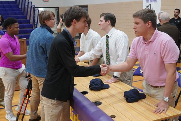 Members of Catholic High School's senior class shake hands with new seminarians Luke Parker, Matthew Lamb and Parker Vail (right), after their seminarian signing day at Catholic High School in Little Rock April 24. (Malea Hargett)