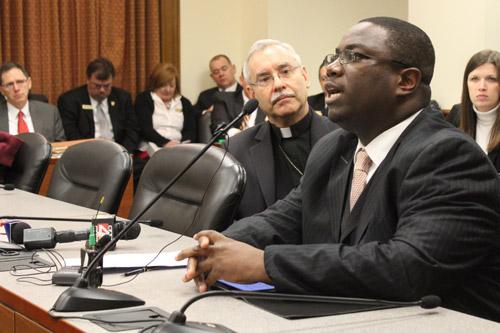 Bishop Anthony B. Taylor looks on as Ronnie Miller-Yow, elder at Wesley Chapel United Methodist Church in Little Rock, testifies against the death penalty.
