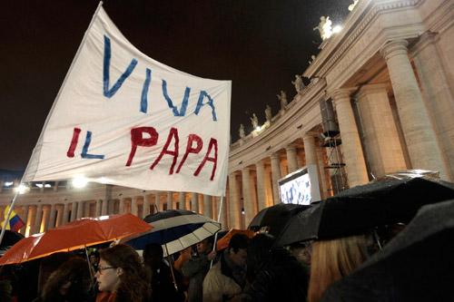 Pilgrims cheer and wave a banner saying "Viva il papa" ("Long live the pope") as white smoke rises from the chimney above the Sistine Chapel, indicating a new pope has been elected at the Vatican, March 13. The conclave to elect a new pope met over two days before making a decision. 
(CNS/Giampiero Sposito, Reuters)