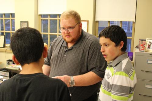 Jerry Wilkerson meets with confirmation students at St. Edward Church, going over the status of their end-of-the-year assignments. Seminarians spend Wednesday evenings during the school year in public ministry projects, such as helping with religious education in local parishes. Dwain Hebda photo