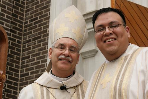 Bishop Anthony B. Taylor congratulates Juan Guido on coming one step closer to his dream of the priesthood. Malea Hargett photo