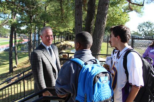Stephen Jones chats with Rocket football players while on a tour of the school's new practice field, paid for with money raised by the capital campaign. Dwain Hebda photo
