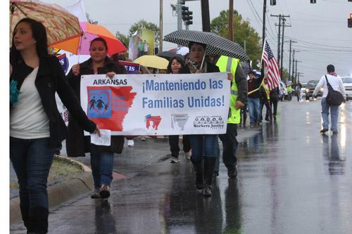 About 100 supporters marched in the rain down Walnut Avenue from 2nd Street to 13th Street for the Oct. 5 immigration reform march in Rogers. Gerard Davenport photo