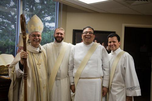 Bishop Anthony B. Taylor pauses for a photo with Deacons Robert Cigainero (left), Juan Guido and Rick Hobbs III before the trio's May 17 ordination. Bob Ocken photo 