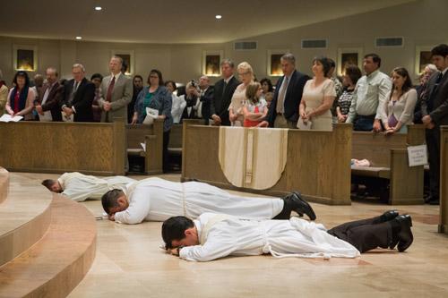 The three deacons lie prostrate on the floor before the altar at Christ the King Church, an act of surrender before God. Bob Ocken photo