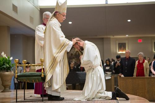 Bishop Taylor lays hands on Robert Cigainero of Texarkana, ordaining him a priest. Cigainero's first assignment is as associate pastor at St. Joseph Church in Conway. Bob Ocken photo