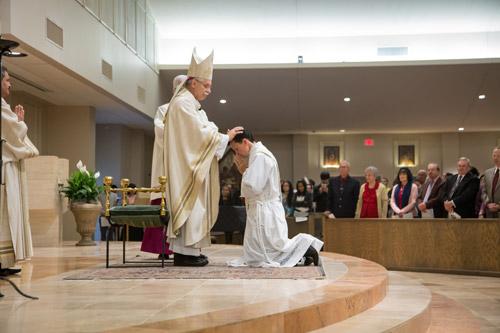 Rick Hobbs III is ordained by Bishop Taylor. Hobbs' first assignment is as associate pastor at St. Vincent de Paul Church in Rogers. Bob Ocken photo