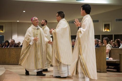 Signifying welcome and unity, Bishop Taylor embraces each of the three newly ordained priests of the Diocese of Little Rock. The bishop was followed by the many other priests in attendance. Bob Ocken photo