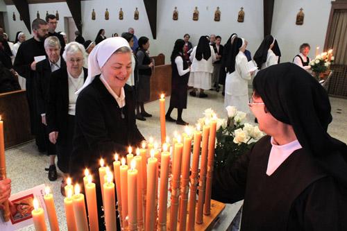 Vowed religious sisters and brothers each accepted a symbolic candle before the Feb. 14 Mass celebrating consecrated life. (Dwain Hebda photo)
