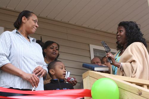 A prayer was said on the front porch of each home and a ceremonial key along with a Bible was given to each family for their “new beginning,” said Shenel Sandidge (right), director of the Habitat for Humanity of Faulkner County. (Aprille Hanson)