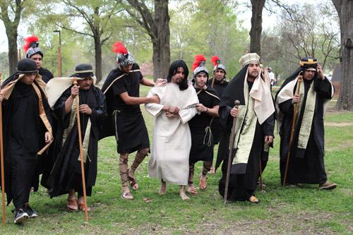 Jesus, portrayed by Ernesto Puentes, is led to Pilate following his arrest and questioning before Caiaphas during living Stations of the Cross put on Good Friday by St. Edward Church in Little Rock. (Dwain Hebda)
