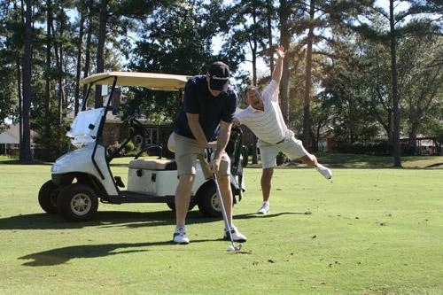 Paul Strack, member of Immaculate Heart of Mary in North Little Rock (Marche), gets ready for his swing while friend Tinker Gibbons, member of Christ the King in Little Rock, jokes in the background during the golf classic. (Aprille Hanson photo) 