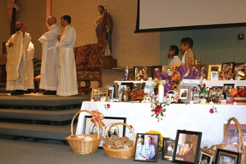 Father Robert Cigainero celebrates the Memorial/Dia de los Muertos bilingual Mass at St. Joseph Church in Conway for All Souls Day Nov. 2. This was the first year Beacon of Hope Ministry for the bereaved and the Hispanic Commission joined together to celebrate All Souls Day with a Mass, “Day of the Dead” altar and a reception following Mass. (Aprille Hanson photo)