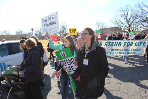 Laura Osborn (left), Veronica Smith, Evelyn Nick and Christina Kaufman of Christ the King Church in Little Rock march ahead of a delegation from Immaculate Conception Church in North Little Rock. (Dwain Hebda photo)