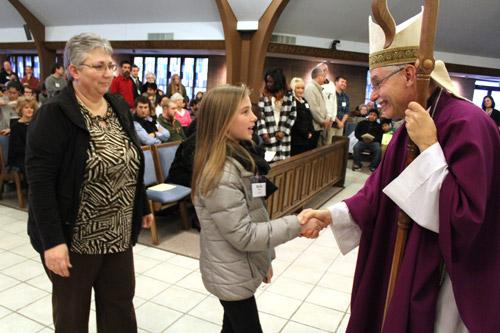 Candidates and catechumens, like the one pictured here being greeted by Bishop Taylor, gathered from more than 20 parishes in central Arkansas. (Dwain Hebda photo)

