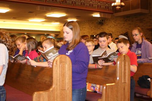 Fifth-grade teacher Jessica Weakley (center) prays the Stations of the Cross with students from St. Joseph School in Conway and parishioners during the 24 Hours for the Lord event March 4. (Aprille Hanson photo)