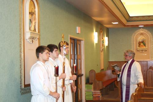 Father John Marconi, pastor at St. Joseph Church in Conway, leads the Stations of the Cross on March 4 with altar servers Nathan Hambuchen (left), Jake Spradlin and Connor Deen, all seniors at St. Joseph School. (Aprille Hanson photo) 
